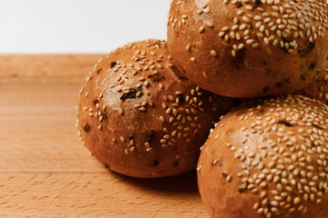 buns with sesame seeds on a chopping Board
