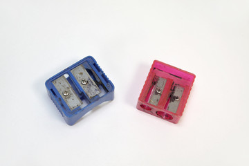 two old pencil sharpeners: red and blue