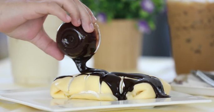 Chocolate syrup with sweet dessert.