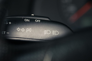 Turn on the car's turn signal. Wipers control. Modern car interior detail.