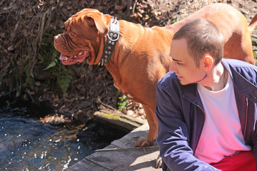 Attractive boy with her pug dog