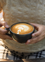 Woman drinking hot latte coffee.