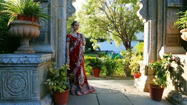 Maharani. Young indian woman in traditional clothing with bridal makeup and oriental jewelry.