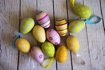 colour easter eggs on a wodden white background