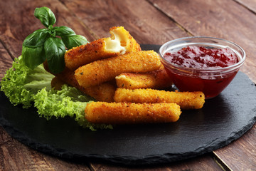 Breaded mozzarella cheese sticks with tomato ketchup and bbq sauce