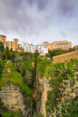 Fototapeta na wymiar Houses hanging from cliffs in Ronda, Spain