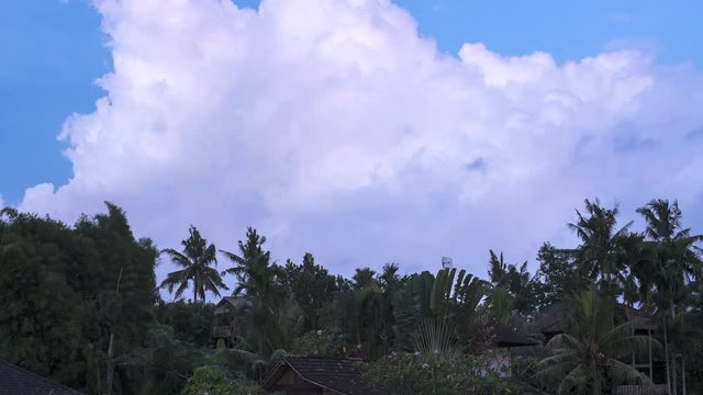 Tropical thunder storm timelapse on a tropical climate island. White fluffy mansoon clouds on a rainy season in Indonesia, Bali