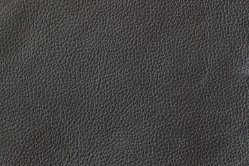 Texture of genuine leather close-up, cowhide. Black color. For natural, artisan backgrounds, substrate composition use, vintage design. Concept of shopping, manufacturing