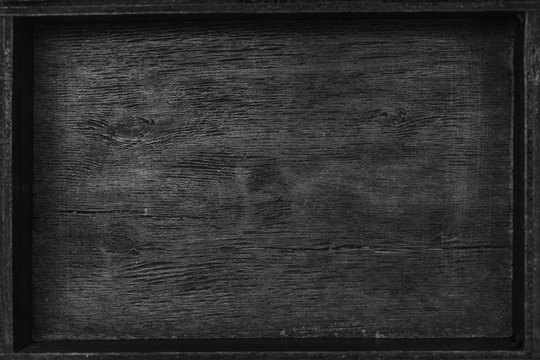 background texture of old wooden surface. The view from the top. Black and white photography. Background with a blank uniform surface. Free space for design, illustration, text