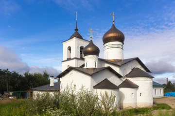 Fototapeta na wymiar View on suspension bridge and St. Nicholas church in Ostrov