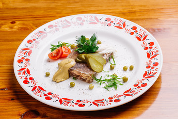 Jellied pork and beef with dill and parsley on the plate