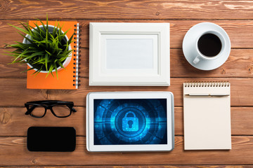 Web security and technology concept with tablet pc on wooden table