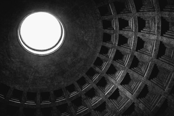 Inside view of the oculus (hole) and dome of the Pantheon in Rome in black and white.