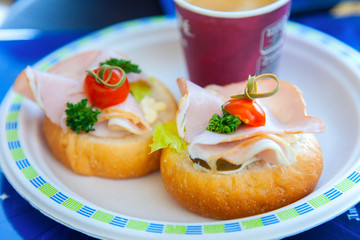 Two sandwiches with ham, parsley and cherry
