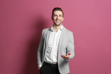Young handsome man on color background © Africa Studio