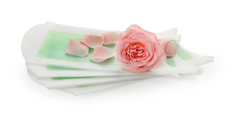 Wax strips for epilation and flower on white background