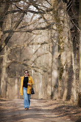Fototapeta na wymiar Woman wearing sunglasses and a yellow coat