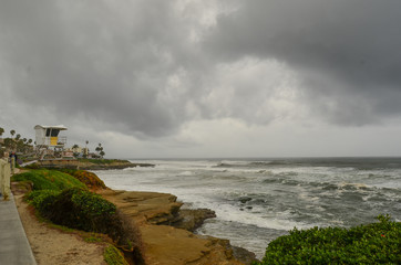 Threatening storm clouds over ocean beach at La Jolla, California, USA