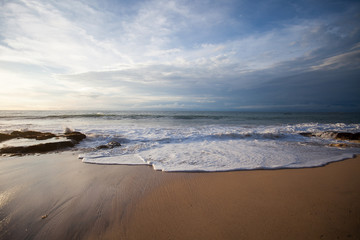 Fototapeta na wymiar Ocean waves breaking on the rocks on the beach