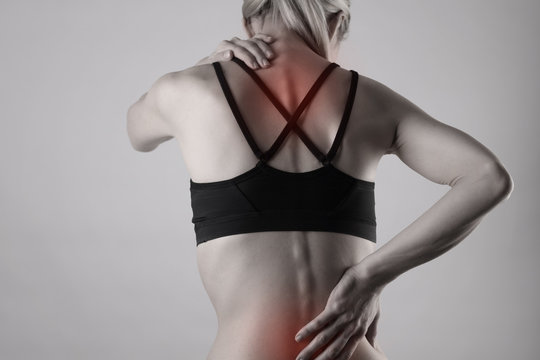 Athletic fitness woman suffering from back pain . Sports exercising injury.