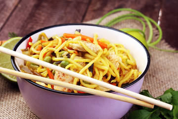 Traditional indonesian meal bami goreng with noodles, vegetables and chicken