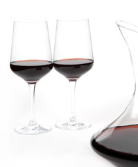 decanter with red wine and glass on a white background