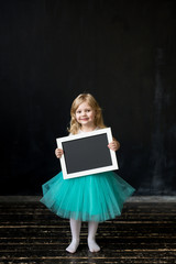 Cute little girl with a frame in her hands