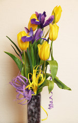 bouquet of yellow tulips and purple irises in the vase