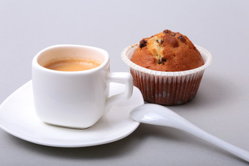 Fresh homemade muffins and white cup of Cappuccino on white background.