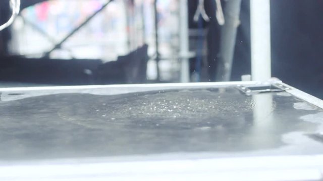 water droplets jumping on the wave of sound.