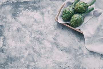 Artichokes over vintage background with copy space