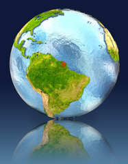 French Guiana on globe with reflection