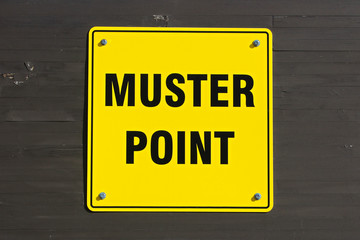 Muster point sign on a wall