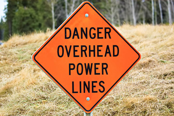 Closeup of a danger overhead power line sign