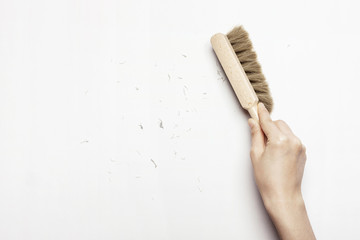 woman(female) hand hold a broom isolated white.