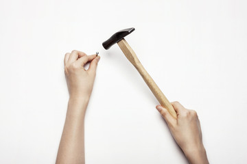 woman(female) hand hold a hammer isolated white.