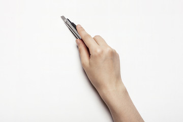 Naklejka premium woman(female) hand hold a knife isolated white.