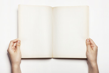 woman(female) hand hold a book spread isolated white.