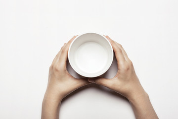 woman(female) hand hold a white ceramic box isolated white.