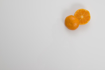 Cut Orange in Corner on White Background
