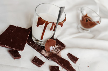 A lot of milk chocolate and a glass of milk