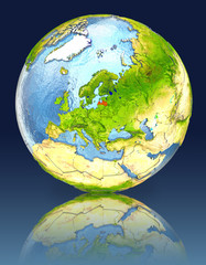 Latvia on globe with reflection