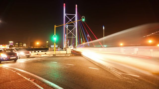 Linear timelapse, right to left at 45 degree angle up, peak traffic time at night at the Nelson Mandela Bridge in the city centre of Johannesburg, South Africa