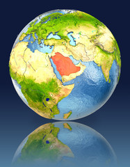 Saudi Arabia on globe with reflection