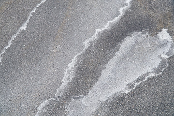 winter ice melting salt on the ground, pattern as background