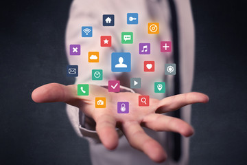Businessman holding colorful applications