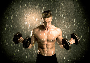 Fitness guy with weight showing muscles