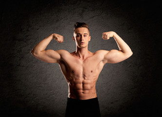 Sexy weight lifter guy showing muscles