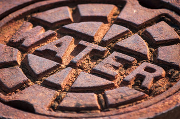 rusty water supply lid in sunshine
