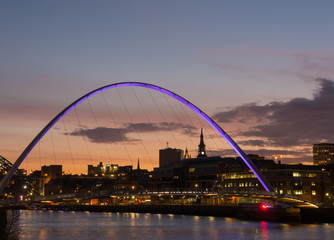 Fototapeta na wymiar Newcastle upon Tyne, England, United Kingdom. The Gateshead Millennium Bridge and its colors during evening time